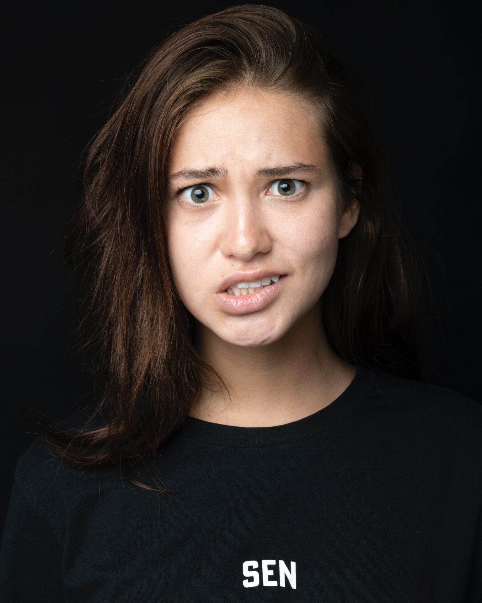 This is an image of a young woman looking confused, scared and lost